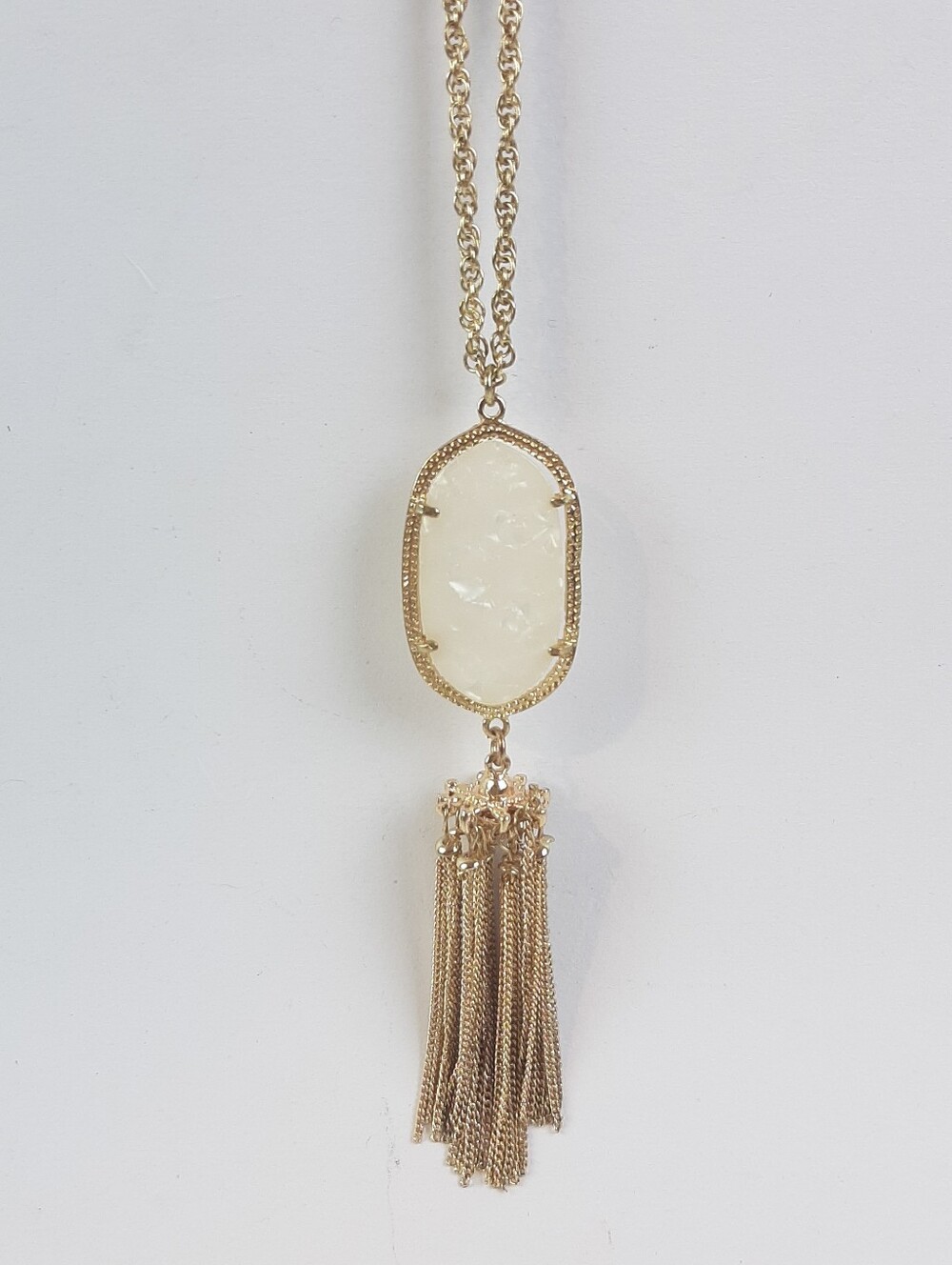 Designer inspired white oval stone and a long metal tassel fashion necklace